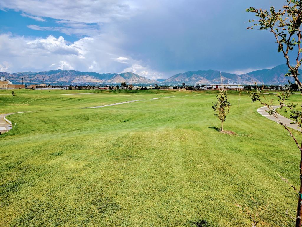 Golf course fairway with clouds in sky